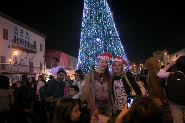 Christians attend the ceremony of lighting a 15-meter-tall Christmas tree in Jaffa-Tel Aviv, Dec. 17, 2017. (Photo: Miriam Alster/Flash90)