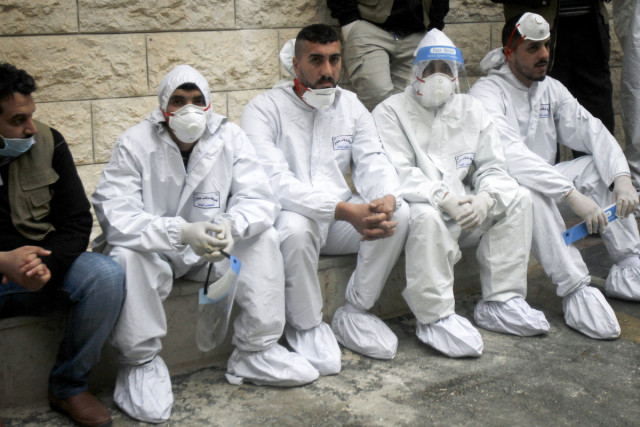 Palestinians dressed in protective clothing as Prime Minister Muhammad Shtayyeh opens a hospital for COVID-19 in the West Bank city of Nablus, Jan. 16, 2021. (Photo: Nasser Ishtayeh/Flash90)
