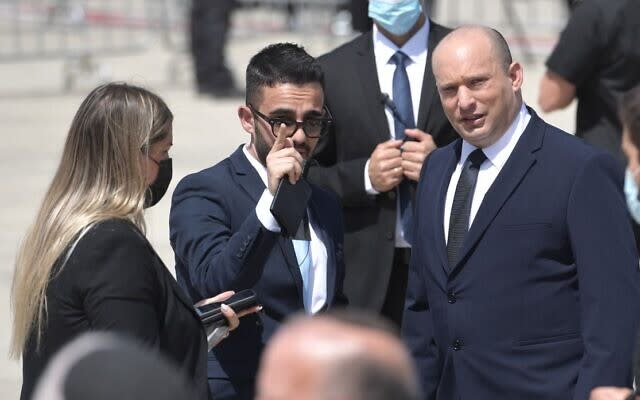 Matan Sidi (center), departing spokesman for Prime Minister Naftali Bennett (R), in an undated photo. (Photo: Government Press Office)