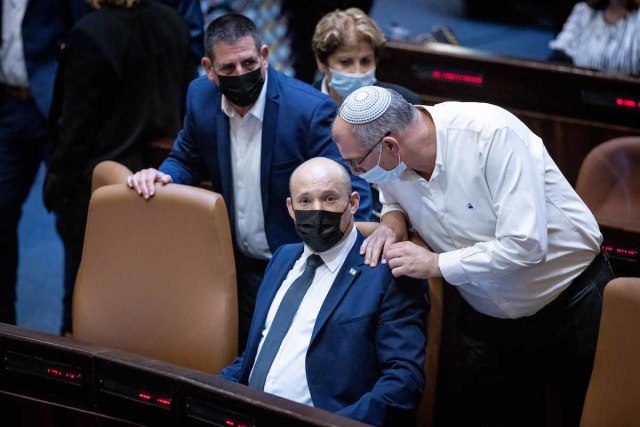 Israeli Prime Minister Naftali Bennett speaks with MK Nir Orbach during a plenum session in the Knesset assembly hall, Oct. 11, 2021. (Photo: Yonatan Sindel/Flash90)