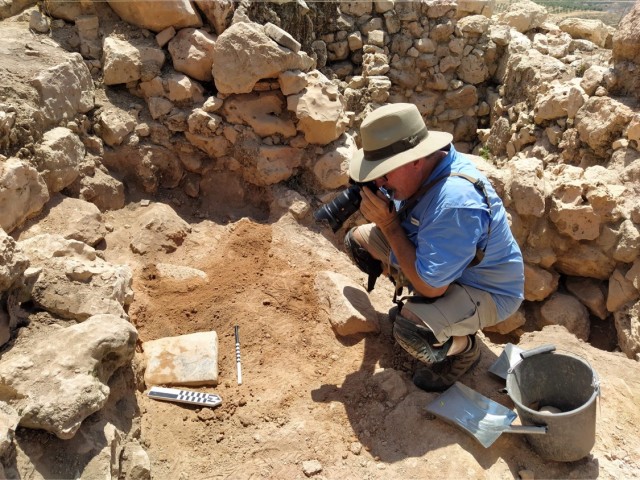 Gary Urie photographing an important stone at Tel Shiloh (Photo courtesy Scott Stripling)