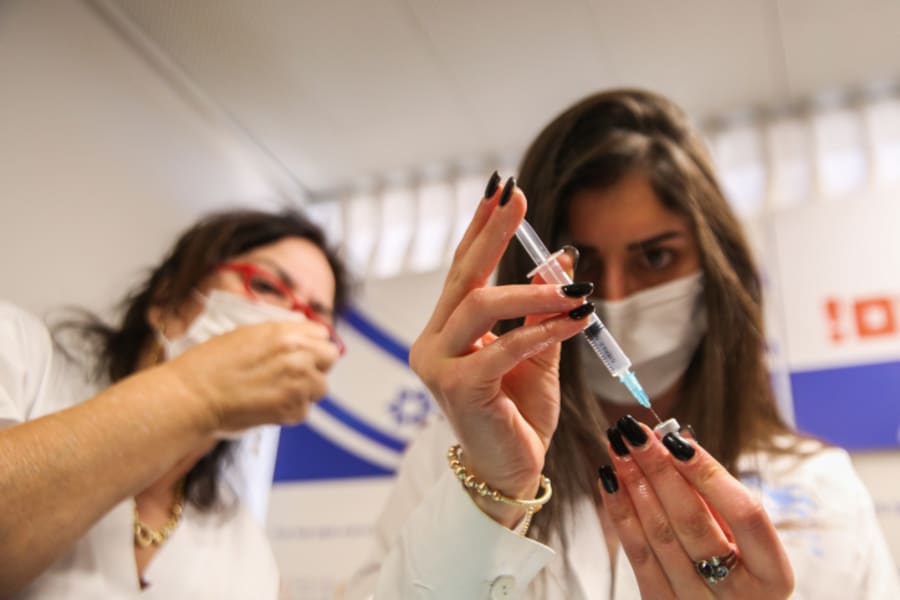An Israeli medical worker prepares a COVID-19 vaccine injection at the Ziv Medical Center in the northern Israeli city of Tzfat on December 21, 2020. (Photo: David Cohen/Flash90)