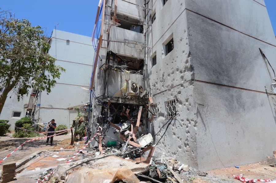 Residents checking the damage to their home in Ashdod that was hit yesterday by a rocket fired from the Gaza Strip, May 18, 2021. (Photo by Avi Roccah/Flash90)