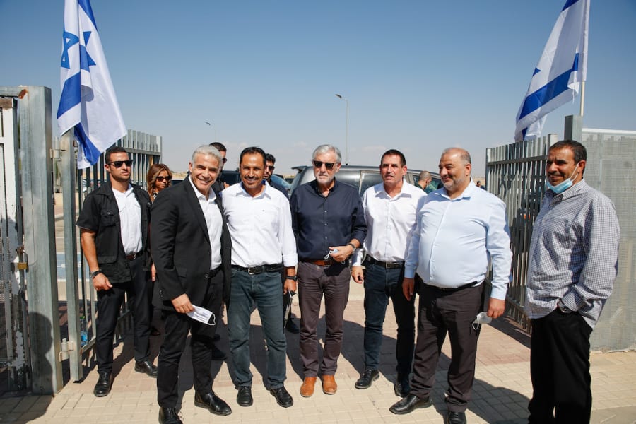 Foreign Minister Yair Lapid and Mansour Abbas, head of the Ra'am party, visit at a high school in the Neve Midbar Regional Council, a region of southern Israel populated by Negev Bedouins, Oct. 21, 2021. (Photo: Flash90)