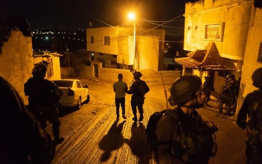 Undated photo of Israeli soldiers arresting a terror suspect thought to be involved in major Hamas cell planning attacks on Israeli targets in the West Bank and Jerusalem. (Photo: Israel Defense Forces)