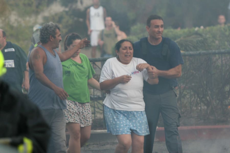 A wounded woman is helped by medics at the site of a Hezbollah rocket attack in the northern Israeli city of Haifa, Aug. 13, 2006. (Photo: Flash90)
