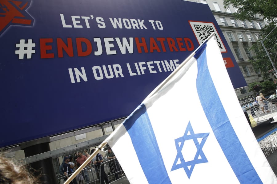 Israeli flag flies as demonstrators display banners and “End Jew Hatred” logos during the Israeli parade on May 22, 2022 in New York City. (Photo: John Lamparski/NurPhoto)