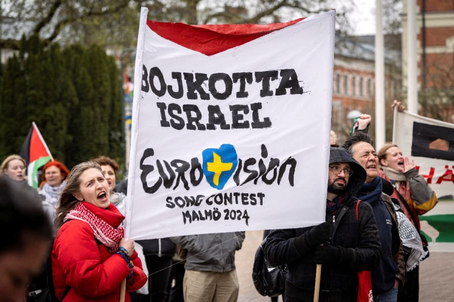 People hold a banner at a demonstration in connection with the municipal board's consideration of a citizens' proposal by the initiative 'No Eurovision in Malmo with Israel's participation,' outside the City Hall in Malmo, Sweden, April 10, 2024 (Photo: Johan NilssonTT News Agency/via REUTERS)
