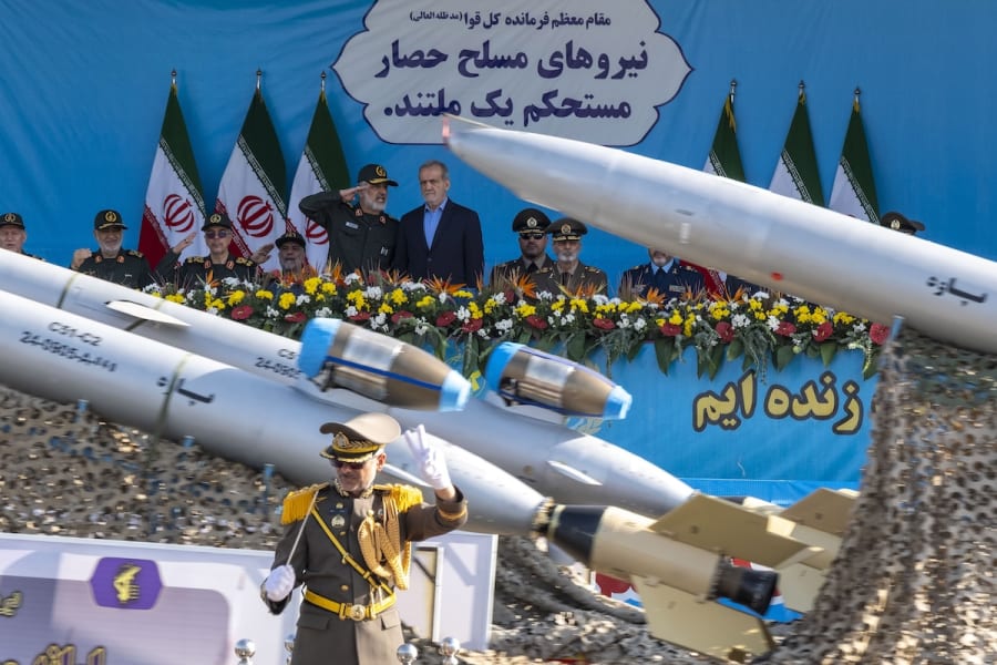 Islamic Revolutionary Guard Corps aerospace division commander General Amir Ali Hajizadeh speaks with Iranian President Masoud Pezeshkian, while Iranian-made unmanned aerial vehicles (UAV), Paveh, are carried by a truck during a military parade, in Tehran, Iran, September 21, 2024. (Photo: Morteza Nikoubazl/NurPhoto)