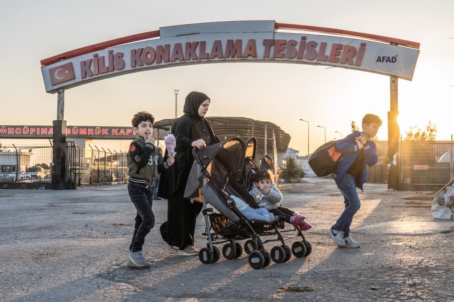 A Syrian family crosses into Syria from Turkey at the Oncupinar border crossing, near the town of Kilis in southern Turkey. Syrian refugees in Turkey started their journey back home following the collapse of the regime of Bashar al-Assad, Dec. 10, 2024. (Photo: Ahmed Deeb/DPA via Reuters)