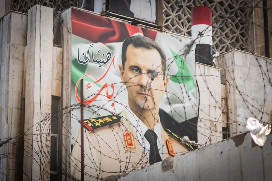 Poster with Syrian President Bashar Al Assad on building facade (Photo: Shutterstock)
