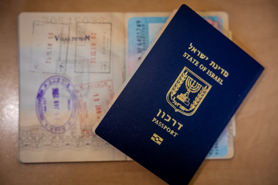 An illustration picture shows a new Israeli passport and an old Israeli passport with different stamps in Jerusalem, January 18, 2023. (Photo: Nati Shohat/Flash90)