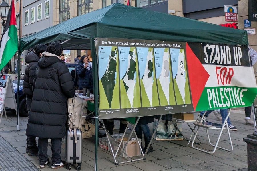 An informational protest booth advocating for Palestine is set up in a bustling street in Munich, Bavaria, Upper Bavaria, Germany, December 28, 2024.(Photo: Michael Nguyen/NurPhoto)