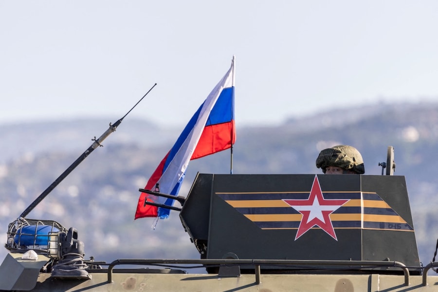 A Russian soldier rides on an infantry fighting vehicle, part of a Russian military convoy heading towards Hmeimim air base in Latakia, on the coast of Syria, December 14, 2024. (Photo: REUTERS/Umit Bektas)