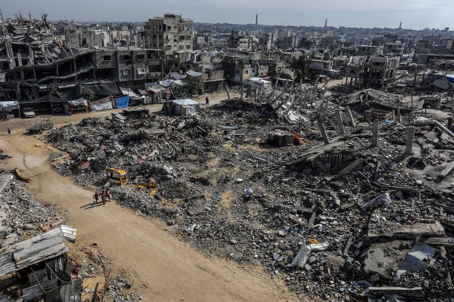 Palestinians walk through the destruction caused in recent war from an Israeli military operation in Khan Younis, in the southern Gaza Strip, February 11, 2025. (Photo: Abed Rahim Khatib/Flash90)
