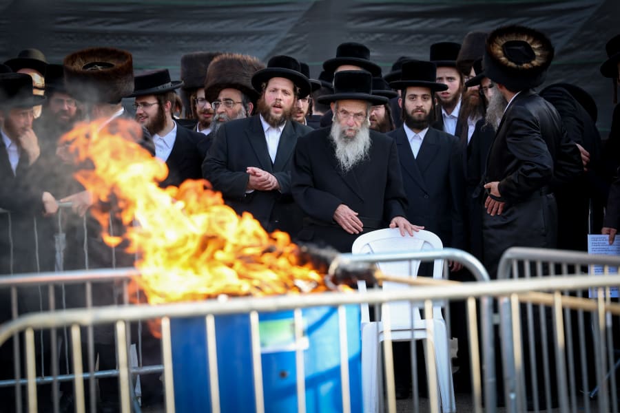 The rebbe of the Chassidic dynasty of Slonim lights a bonfire during Lag B'Omer celebrations, in Meron, May 9, 2023. (Photo: David Cohen/Flash90