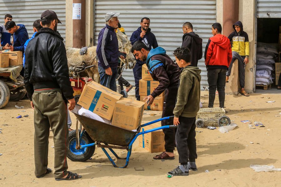 Palestinians receive food aid from the World Food Program (WFP) in cooperation with the United Nations Relief and Works Agency (UNRWA) in Khan Yunis, in the southern Gaza Strip, Feb. 19, 2025. Photo by Abed Rahim Khatib/Flash90