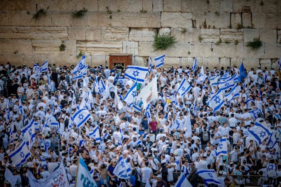 Jews hold Israeli flags as they dance at the Western Wall in Jerusalem's Old City, during Jerusalem Day celebrations, May 18, 2023. (Photo: Yonatan Sindel/Flash90)