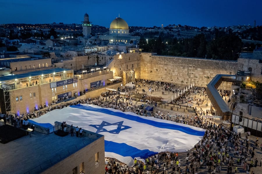 People hold a giant Israeli national flag at the Western Wall in Jerusalem Old City, on the eve of Jerusalem Day, May 25, 2025. (Photo: Chaim Goldberg/Flash90)