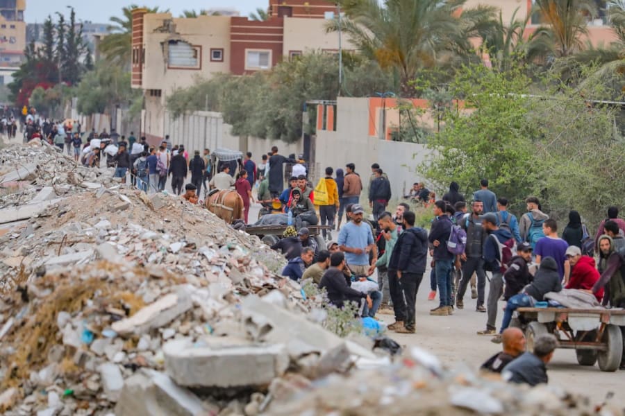 Palestinians walking near aid distribution point in the Netzarim Corridor in the central Gaza Strip, June 9, 2025. (Photo: Ali Hassan/Flash90)