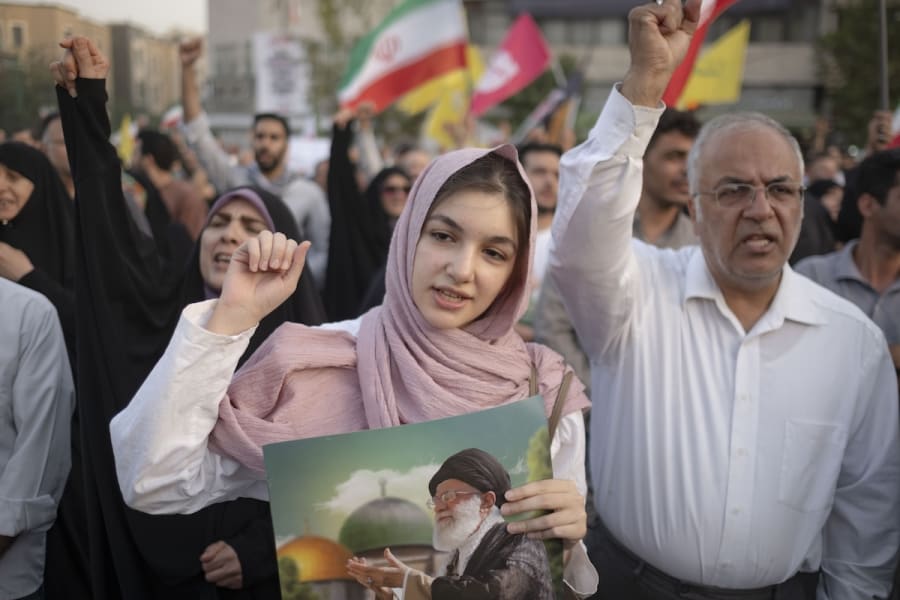 A young Iranian woman holds a portrait of Iran's Supreme Leader, Ayatollah Ali Khamenei, and shouts anti-Israeli slogans during a rally to celebrate the ceasefire, which she believes is a victory over Israel in a 12-day war, in downtown Tehran, Iran, on June 24, 2025. (Photo: Morteza Nikoubazl/NurPhoto)