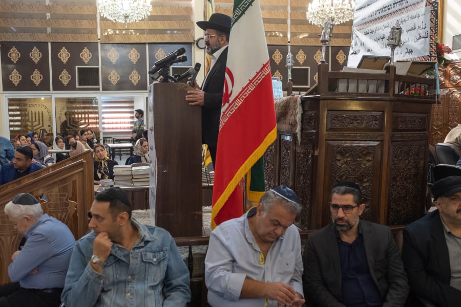 Rabbi Younes Hamami Lalehzar (top), leader of Iranian Jews, delivers a speech as he stands next to an Iranian flag at a synagogue in downtown Tehran, October 30, 2023. (Photo: Reuters)