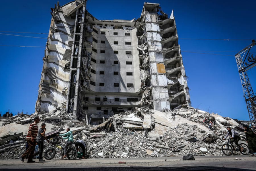 Palestinians walk past a building destroyed by Israeli air strikes, in the city of Rafah in the southern Gaza Strip, on April 6, 2024. Photo by Abed Rahim Khatib/Flash90