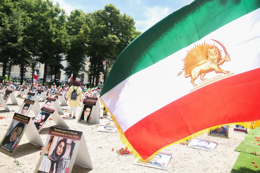 Signs displaying portraits of political prisoners in Iran were placed on Rue de Constantine alongside a flag of the Shah of Iran to protest against political executions in Iran by the mullahs regime, in Paris, July 8, 2025. (Photo: Quentin de Groeve / Hans Lucas via Reuters)