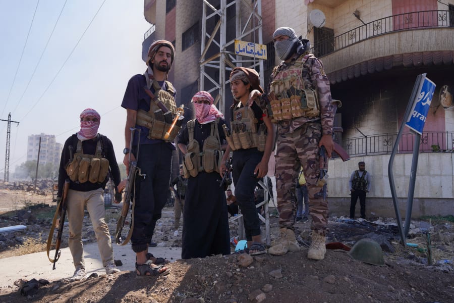 Bedouin fighters stand together, following the Syrian presidency's announcement of a ceasefire after days of violence in Sweida province triggered by clashes between Bedouin fighters and Druze factions, in Sweida, Syria, July 19, 2025. REUTERS/Karam al-Masri