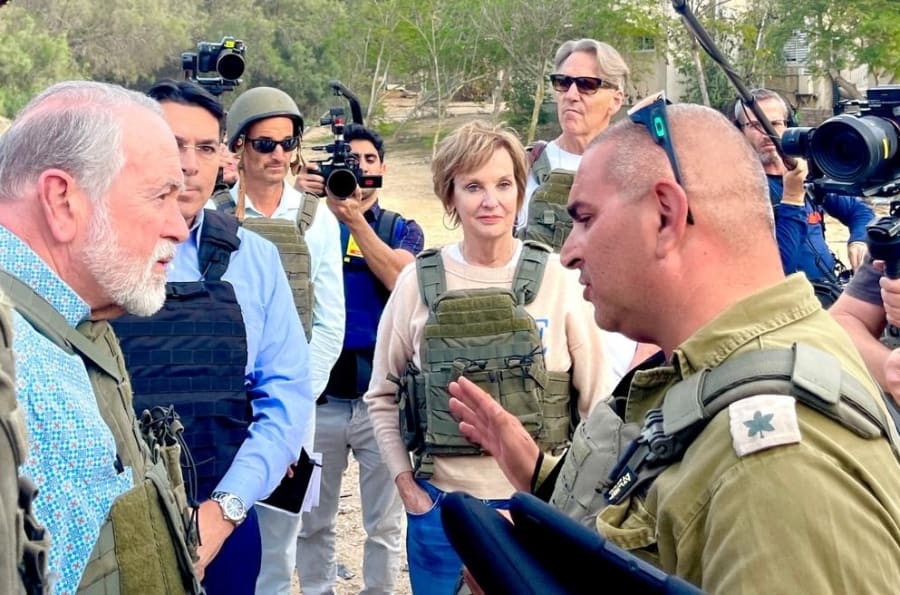US Ambassador Mike Huckabee discusses the atrocities in Kfar Aza with IDF Major Liad Diamond. (photo credit: All Israel News staff)