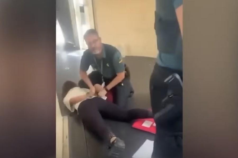 The group’s director being arrested and handcuffed (Photo: Screenshot)