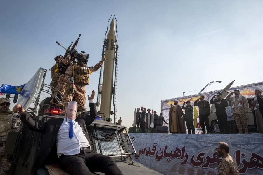 Commanders of the Islamic Revolutionary Guard Corps (IRGC) salute as an unidentified man wearing a mask featuring a portrait of Israeli Prime Minister Benjamin Netanyahu performs, while being carried by an IRGC anti-riot armored vehicle during a military rally in downtown Tehran, Iran, January 10, 2025. (Photo: Morteza Nikoubazl/NurPhoto)