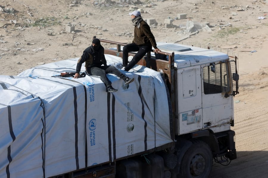 Illustration: Gunmen in Gaza seen on humanitarian aid trucks. Rafah, southern Gaza Strip, January 21, 2025. REUTERS/Mohammed Salem