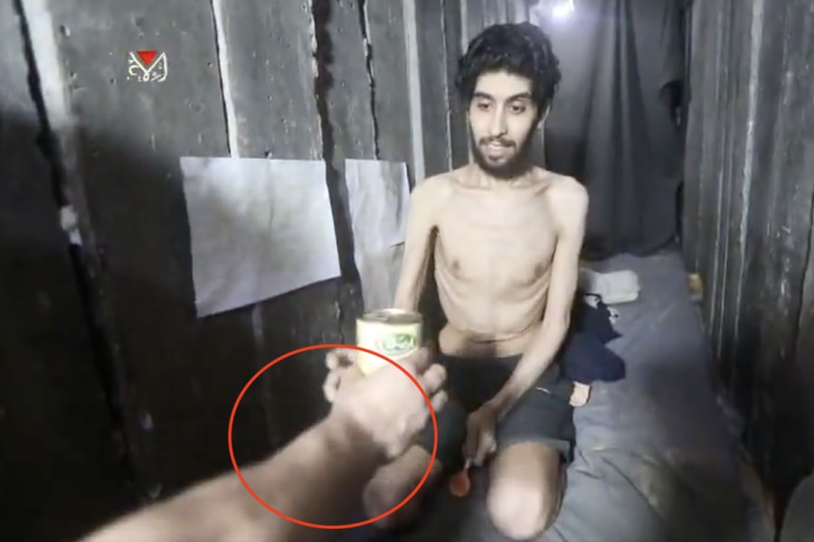 Evyatar David Israeli hostage handed a can of food by well-fed Hamas terrorist, Aug. 2 2025. Photo: (Photo used under section 27A of the copyright law)