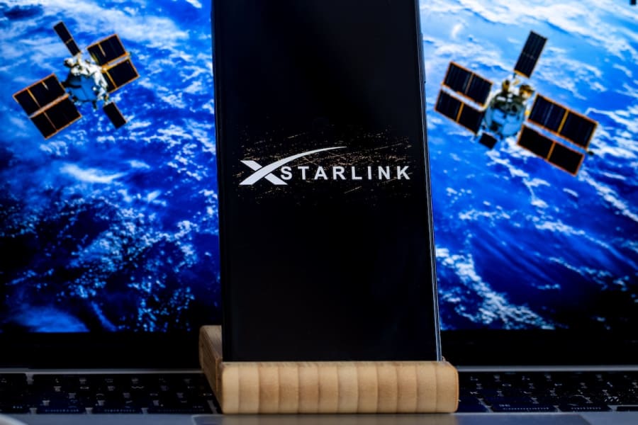 STARLINK logo is sharp displayed in the foreground, while the stylite in displayed on computer in the background, March, 11, 2025. (Photo: Shutterstock)