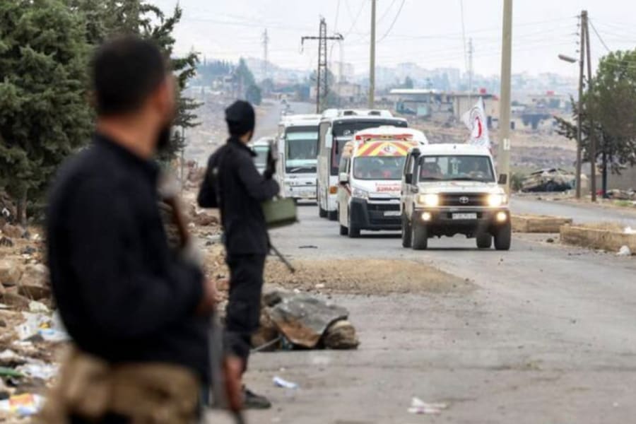 Convoy of buses led by a vehicle and ambulance of the Syrian Red Crescent carrying evacuated Bedouin families in southern Syria's Suweida as security forces deploy in the area, July 21, 2025. (Photo: Syrian Arab News Agency (SANA) handout)