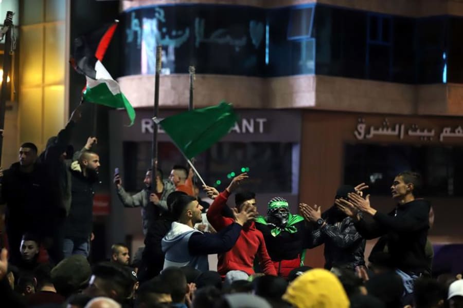 Palestinians celebrate following the deadly terror attack tonight, in the West Bank city of Hebron, Jan. 27, 2023. Photo by Wisam Hashlamoun/Flash90