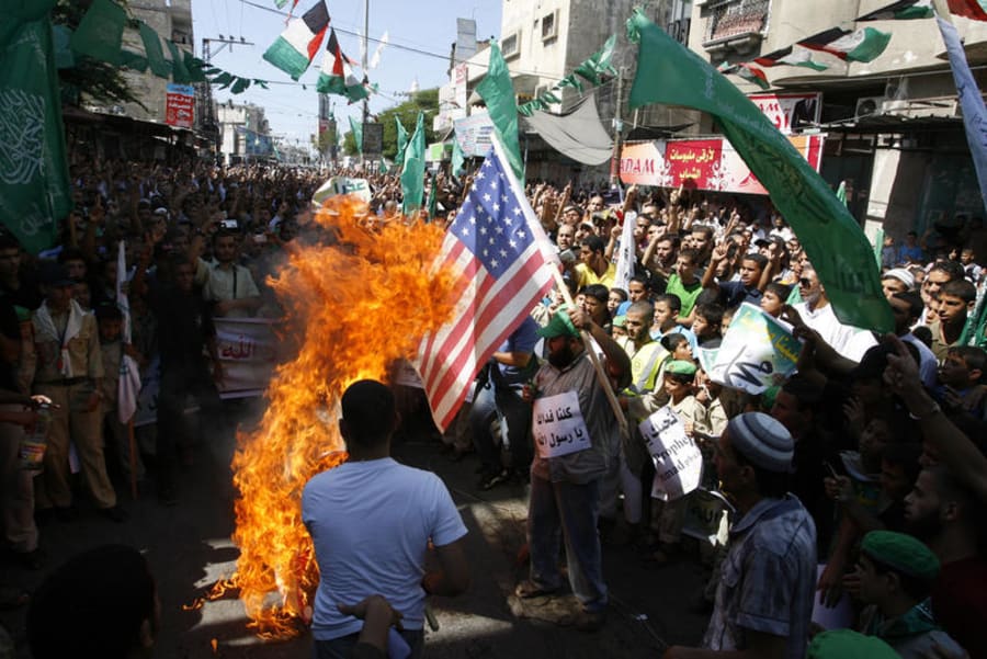 Palestinian men burn the US flag during a protest against a film mocking Islam, in Rafah, southern Gaza Strip, on September 14, 2012. (Photo: Abed Rahim Khatib/Flash90)
