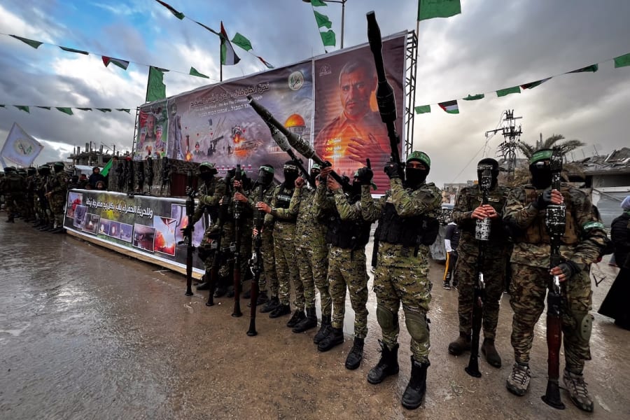 Members of the Al-Qassam Brigades guard while Palestinians wait for the hand over of Israeli hostages to the Red Cross, as part of the ceasefire agreement between Israel and Hamas, in Rafah, Feb. 22, 2025. (Photo: Saeed Mohammed/Flash90)