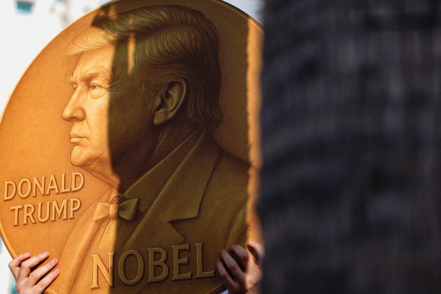 A protester holding a sign with US President Donald Trump on a Nobel Peace Prize coin at a tally demanding the immediate release of Israeli hostages and ending the war in Gaza, outside the U.S. Consulate in Tel Aviv, September 2, 2025. (Photo: Ammar Awad/Reuters)