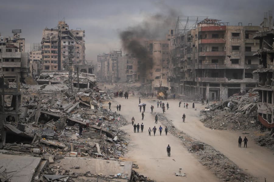 Palestinians walk among the ruins of their homes in the Shujaiya neighborhood of eastern Gaza, October 16, 2025. Photo by Khalil Kahlout/Flash90