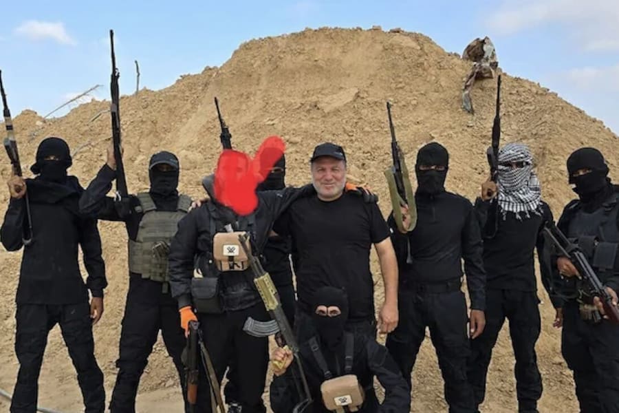 Hossam al-Astal (C) surrounded by armed members of his militia, 'Strike Force Against Terror,' in an undated picture (Photo: Social media)