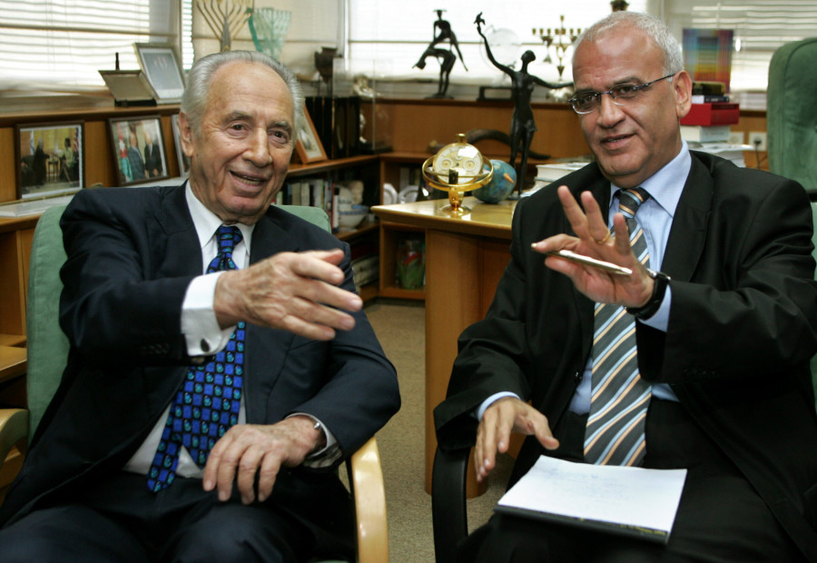 Then Israeli Deputy Prime Minister and Vice Premier Shimon Peres (L) attend a meeting with Palestinian Authority negotiator Saeb Erekat in Tel Aviv October 14, 2005. (Photo: REUTERS/Gil Cohen Magen)