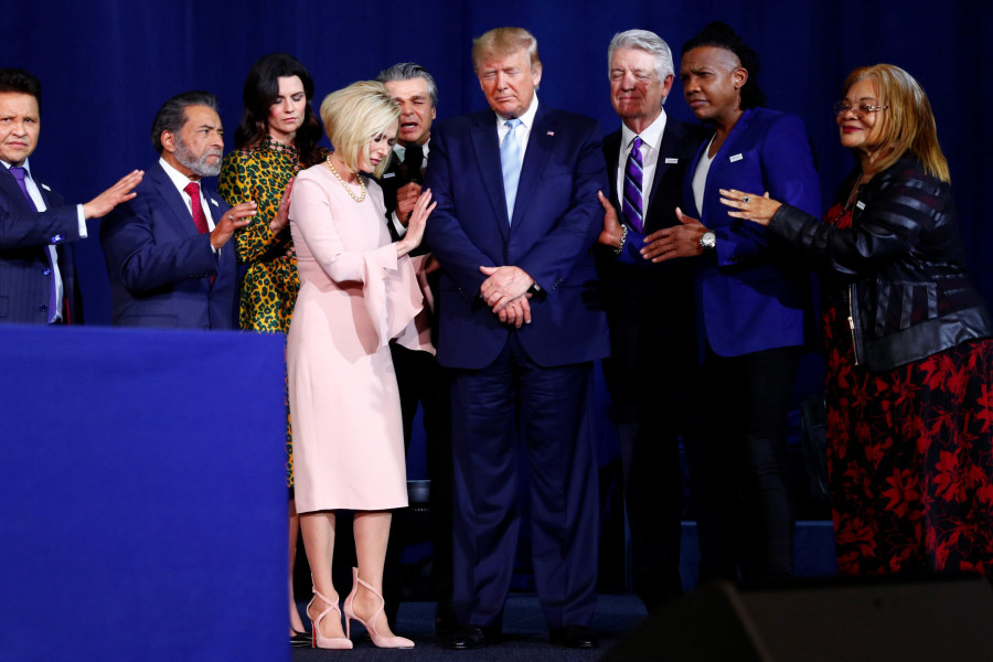 U.S. President Donald Trump participates in a prayer at an Evangelicals for Trump Coalition meeting in January 2020. (Photo: REUTERS/Tom Brenner)