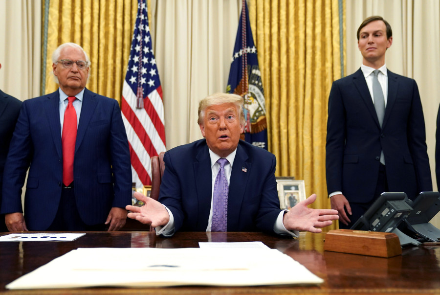 FILE PHOTO: Flanked by U.S. Ambassador to Israel David Friedman and White House senior adviser Jared Kushner, U.S. President Donald Trump speaks about a peace deal reached between Israel and the United Arab Emirates during from the Oval Office of the White House in Washington, U.S., August 13, 2020. (photo credit: REUTERS/Kevin Lamarque/File Photo)