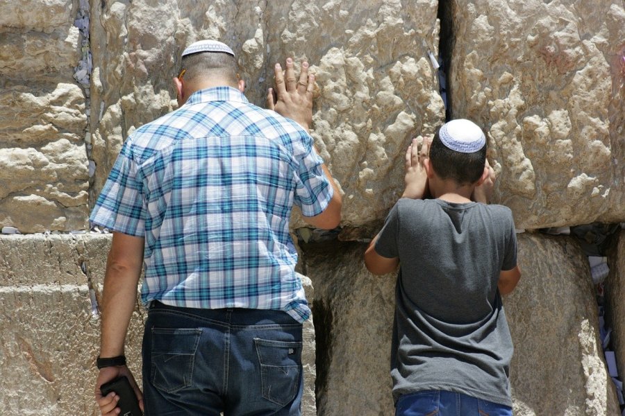Illustrative image - a man and boy praying at the Western Wall in Jerusalem's Old City