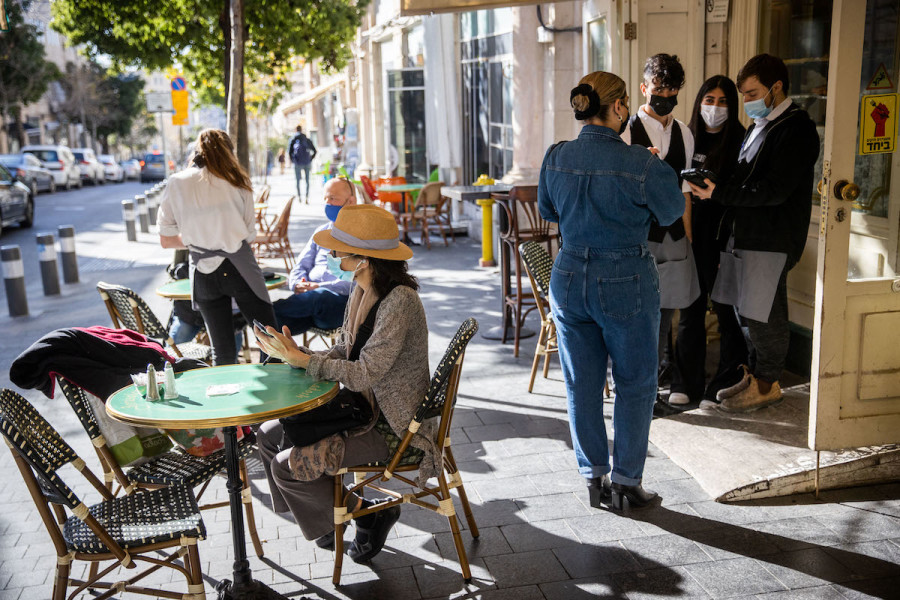 Customers sit at the Kadosh Cafe Patisserie in Jerusalem after it was reopened on March 7, 2021. (Photo: Yonatan Sindel/Flash90)