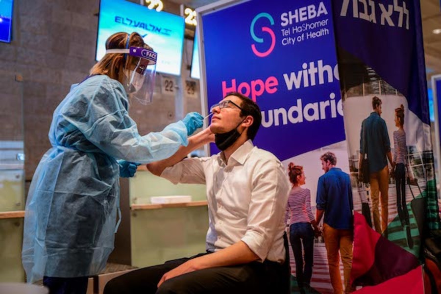 A medical technicians tests a passenger for COVID-19 at the Ben-Gurion International Airport near Tel Aviv on March 8, 2021. (Photo: Avshalom Sassoni/Flash90)