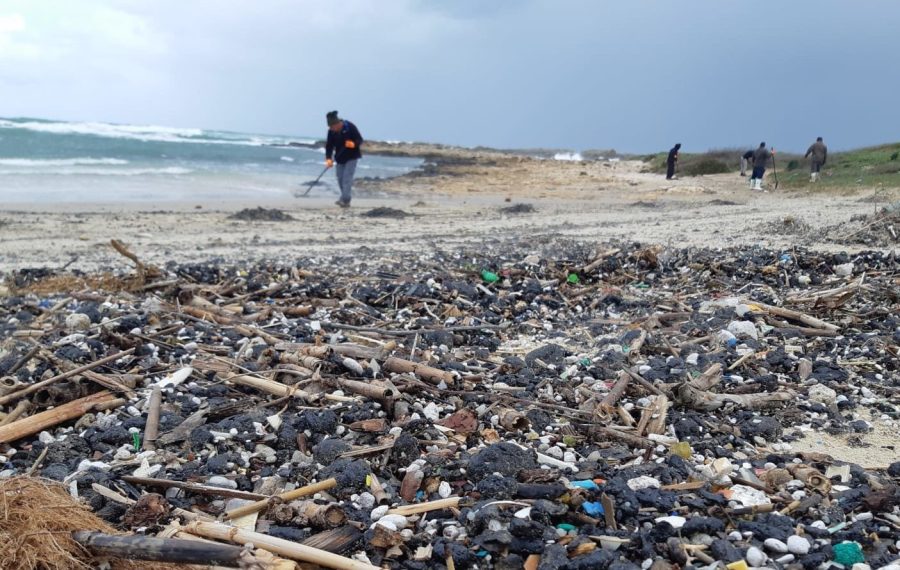 Cleaners work to remove tar at Tel Dor beach in northern Israel. (Photo: Yossi Ozen/Israel Nature and Parks Authority)
