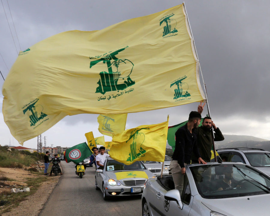 FILE PHOTO: A supporter of Lebanon's Hezbollah gestures as he holds a Hezbollah flag in Marjayoun, Lebanon May 7, 2018. (Photo: REUTERS/Aziz Taher)